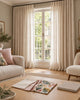 Illustrative living room with linen-look curtains and fabric samples prepared for a curtain consultation